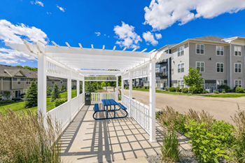 Crossroads at elm creek pergola-covered grilling & seating area